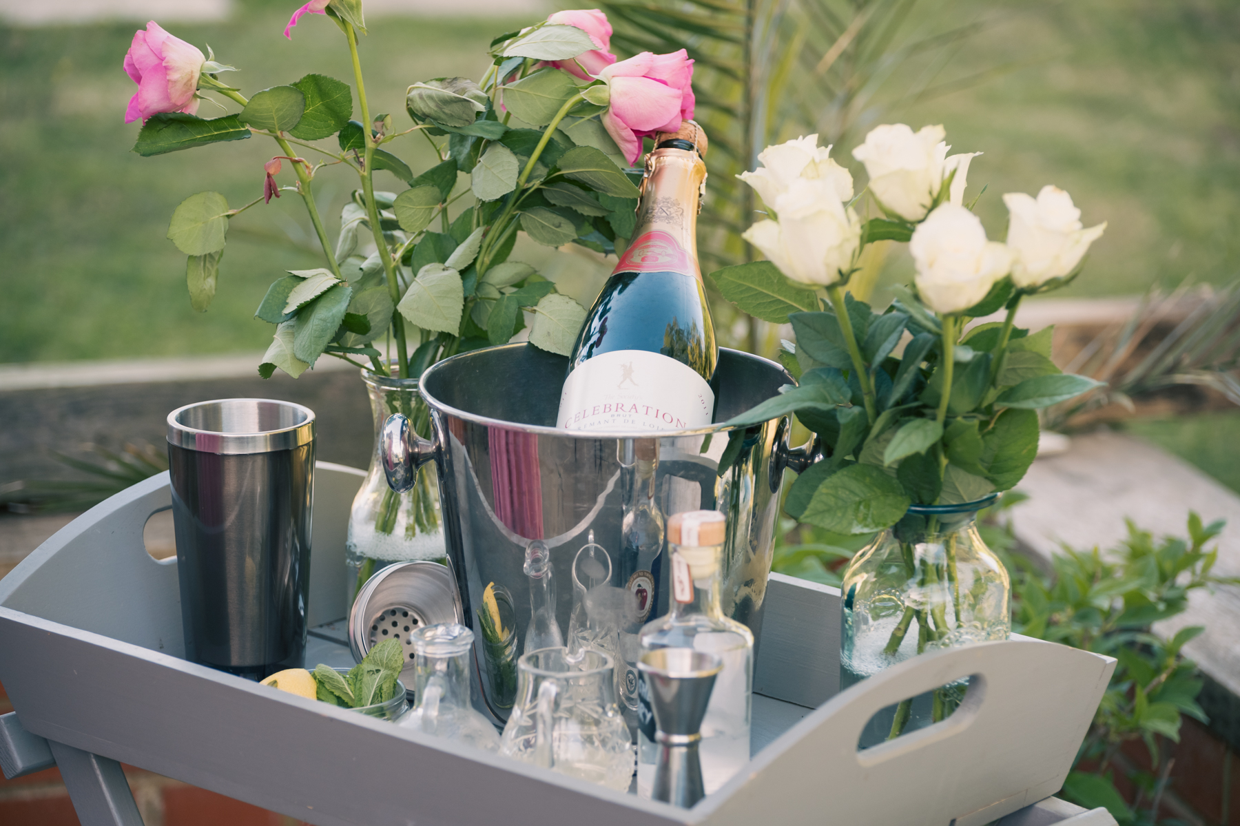 Drinks trolley with champagne, roses and glassware at a celebration